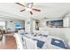 Charming dining area features modern lighting and leads into the kitchen and living room at 13036 W Cross Dr, Littleton, CO 80127