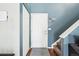View of the entryway with a stairway and entry closet and blue painted walls at 13036 W Cross Dr, Littleton, CO 80127
