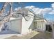 Charming two-story home featuring an attached two-car garage and a covered front entry at 13036 W Cross Dr, Littleton, CO 80127