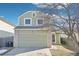 Charming two-story home featuring an attached two-car garage and a well-maintained front yard at 13036 W Cross Dr, Littleton, CO 80127