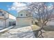 Charming two-story home with an attached two-car garage and tree-lined front yard at 13036 W Cross Dr, Littleton, CO 80127