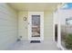 View of a covered front porch with exterior lighting and a storm door entry at 13036 W Cross Dr, Littleton, CO 80127