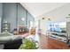 Spacious living room featuring hardwood floors, a fireplace and a large television at 13036 W Cross Dr, Littleton, CO 80127