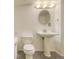 Bright bathroom with a pedestal sink, toilet, and tub shower at 13634 Monroe St, Thornton, CO 80602
