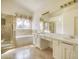 Bright bathroom with dual vanity, soaking tub, and separate shower at 13634 Monroe St, Thornton, CO 80602