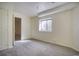 Cozy bedroom features neutral carpet, a bright window, and fresh white walls at 13634 Monroe St, Thornton, CO 80602