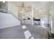Spacious living room with fireplace, staircase, and open access to kitchen and dining areas at 13634 Monroe St, Thornton, CO 80602