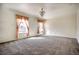 Expansive living room with natural lighting and neutral carpet at 13634 Monroe St, Thornton, CO 80602