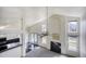 Open-concept living area with high ceilings, fireplace, and views of the kitchen at 13634 Monroe St, Thornton, CO 80602