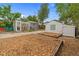 Spacious backyard with raised garden beds and a greenhouse, providing ample space for outdoor activities at 936 Utica St, Denver, CO 80204