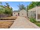 Cozy backyard featuring a small greenhouse and concrete patio, perfect for gardening and outdoor living at 936 Utica St, Denver, CO 80204