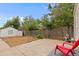 Spacious backyard featuring a detached garage, privacy fence, and mature trees at 936 Utica St, Denver, CO 80204