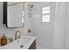 Bright bathroom featuring modern sink with gold faucet, shower, and decorative accents at 936 Utica St, Denver, CO 80204