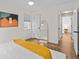 Bright bedroom features hardwood floors, white walls, ceiling fan, and modern décor at 936 Utica St, Denver, CO 80204