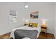 Bright bedroom featuring wood floors, ceiling fan, and two side tables at 936 Utica St, Denver, CO 80204