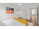 Cozy bedroom with hardwood floors, white walls, a comfortable bed, and stylish decor at 936 Utica St, Denver, CO 80204