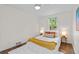 Bright bedroom with hardwood floors, a comfortable bed, stylish decor, and plenty of natural light at 936 Utica St, Denver, CO 80204