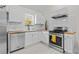 Bright kitchen features white cabinets, stainless steel appliances, wood countertops, and subway tile backsplash at 936 Utica St, Denver, CO 80204