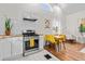 Bright kitchen and dining area featuring stainless steel appliances, white cabinets, and wood countertops at 936 Utica St, Denver, CO 80204