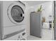 Laundry room features a washer and dryer, and view of the kitchen at 936 Utica St, Denver, CO 80204