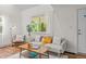 Bright living room with hardwood floors, sheer curtains, and comfortable furniture for a relaxing atmosphere at 936 Utica St, Denver, CO 80204
