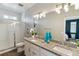 Bright bathroom showcasing a double vanity, granite countertops, and a glass-enclosed shower at 9612 Reunion Pkwy, Commerce City, CO 80022
