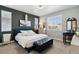 Comfortable bedroom boasts a blue bed frame, modern decor, and plenty of natural light at 9612 Reunion Pkwy, Commerce City, CO 80022
