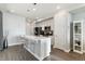 Bright, modern kitchen features a central island, stainless appliances, and ample cabinet space at 9612 Reunion Pkwy, Commerce City, CO 80022