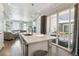 Open-concept living space with a modern kitchen, comfortable seating, and access to an outdoor patio at 9612 Reunion Pkwy, Commerce City, CO 80022