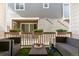 Cozy outdoor patio with comfortable seating, planters, and view of the backyard at 9612 Reunion Pkwy, Commerce City, CO 80022
