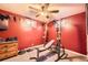 Basement gym area with red walls, equipment and an adjacent small window at 11816 Spring Dr, Northglenn, CO 80233