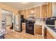 Functional kitchen showcasing wooden cabinets, a stainless steel refrigerator, and a compact layout at 11816 Spring Dr, Northglenn, CO 80233