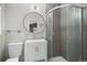 Modern bathroom featuring a stylish vanity, a glass-enclosed shower, and a round mirror at 153 Sawmill Ln, Idaho Springs, CO 80452