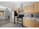 Modern kitchen featuring stainless steel appliances, bright wooden cabinets, and tiled backsplash at 153 Sawmill Ln, Idaho Springs, CO 80452