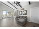 Bright living room with vaulted ceilings, dark beams, and large windows with outdoor views at 153 Sawmill Ln, Idaho Springs, CO 80452
