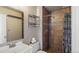 This bathroom features a new vanity, mirror, toilet and tile shower at 7881 Allison Way # 204, Arvada, CO 80005