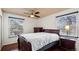 This primary bedroom has two windows, a ceiling fan and hardwood floors at 7881 Allison Way # 204, Arvada, CO 80005