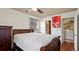 This bedroom features hardwood floors, a ceiling fan, and an attached bathroom and laundry room at 7881 Allison Way # 204, Arvada, CO 80005