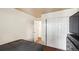 This bedroom features neutral walls, an open door to another room, and closet with bi-fold doors at 7881 Allison Way # 204, Arvada, CO 80005