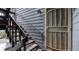 Close-up of a unit entrance featuring dark wood stairs and a secure screen door at 7881 Allison Way # 204, Arvada, CO 80005