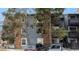 Exterior view of a multifamily home with brick and siding and mature trees at 7881 Allison Way # 204, Arvada, CO 80005