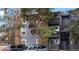 Exterior view of a multifamily home with brick and siding and mature trees at 7881 Allison Way # 204, Arvada, CO 80005