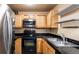 Practical kitchen featuring stainless steel appliances and black countertops at 7881 Allison Way # 204, Arvada, CO 80005