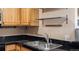 Bright kitchen features stainless steel sink and fixtures, plus open shelving at 7881 Allison Way # 204, Arvada, CO 80005