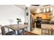Charming kitchen featuring stainless steel appliances, wood cabinets, and breakfast bar seating at 7881 Allison Way # 204, Arvada, CO 80005