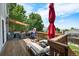 Outdoor deck with lounging and dining areas, plus a grill and an umbrella at 22379 E Dorado Ave, Aurora, CO 80015