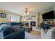 Cozy living room with a fireplace, plush seating, and ample natural light at 22379 E Dorado Ave, Aurora, CO 80015