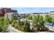 A bird's eye view shows a community pool and clubhouse surrounded by well-maintained landscaping and multi-story condo buildings at 5677 S Park Pl # 303, Englewood, CO 80111