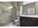 Modern bathroom with glass-enclosed shower, sleek vanity with a white countertop, and tile flooring at 5677 S Park Pl # 303, Englewood, CO 80111