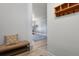Welcoming entryway with a decorative bench, a coat rack, and a glimpse into the bright, open living spaces at 5677 S Park Pl # 303, Englewood, CO 80111